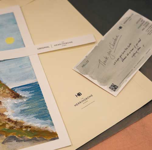 A close up art cards by the herringbone studio and the packaging