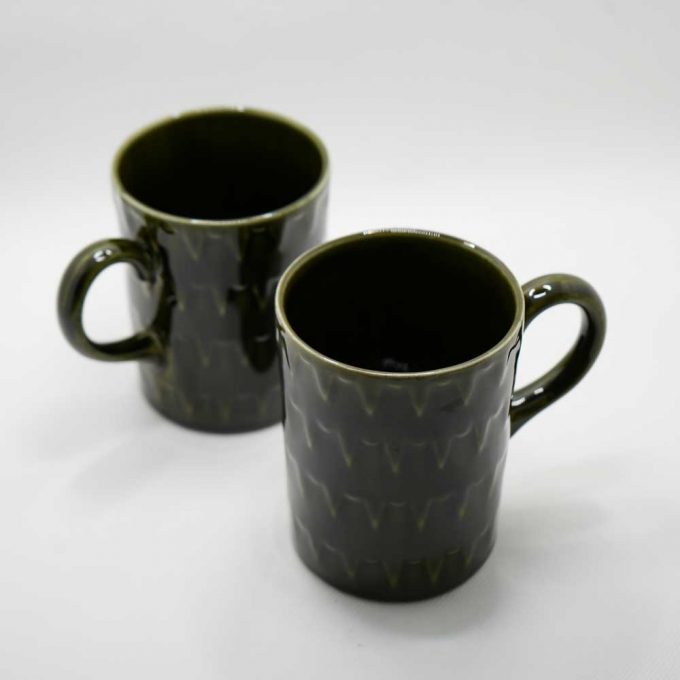 Two dark green mugs side by side