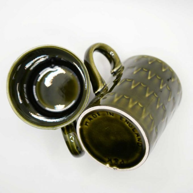 Two dark green mugs side by side