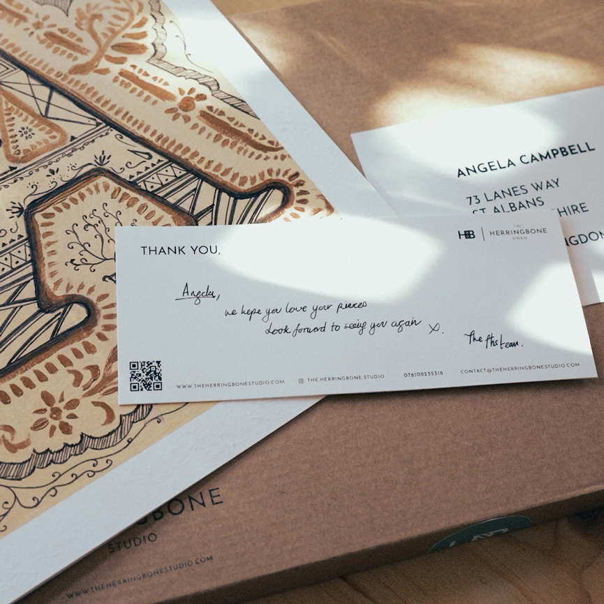 A close up art cards by the herringbone studio and the packaging