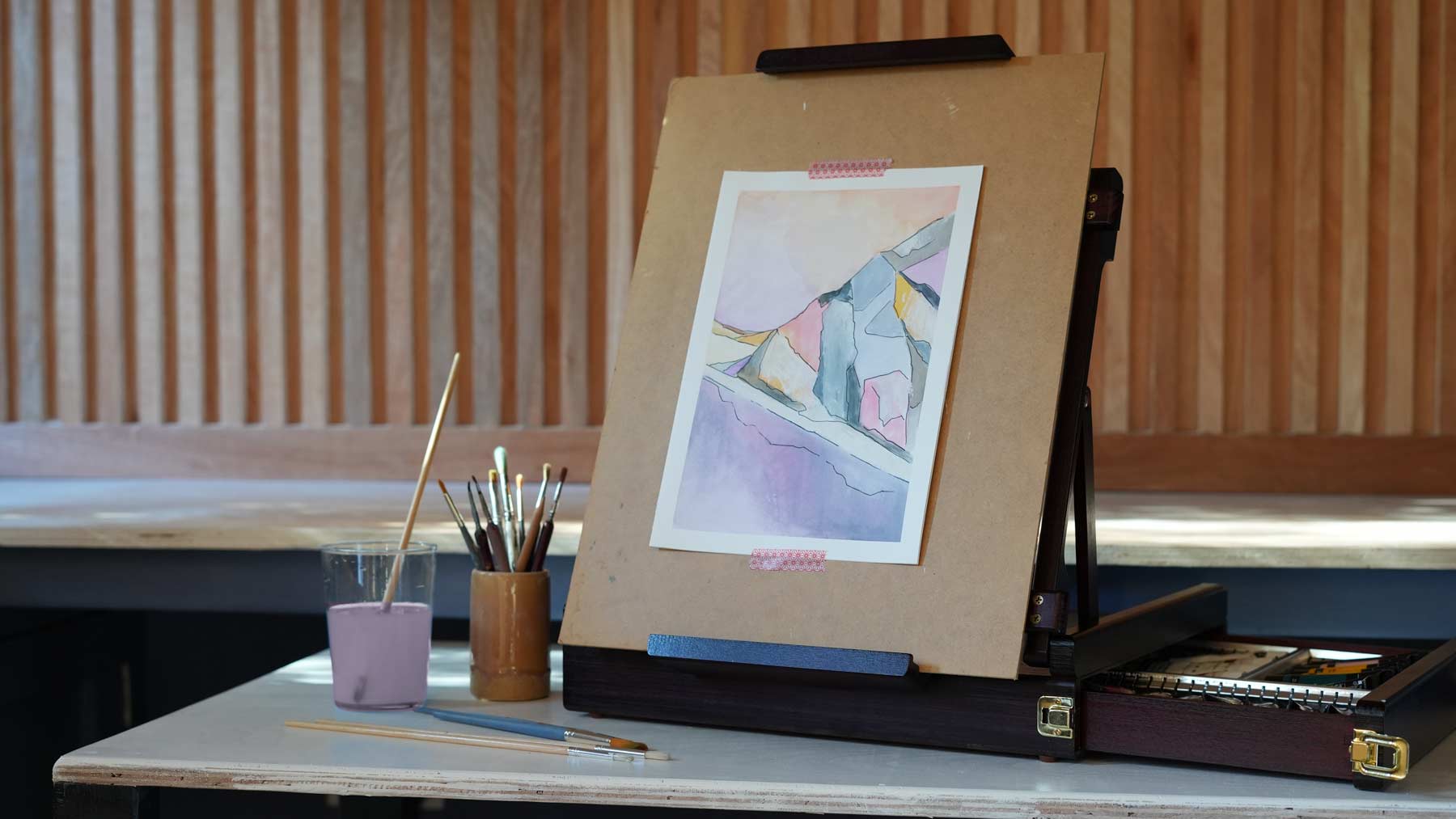 A easel and set of brushes and paint in The Herringbone Studio